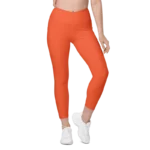 Legging de sport pour femme taille haute avec double poche de couleur orange. Coupe taille haute pour un effet sculptant et un maintien optimal. Photo porté du produit de devant.