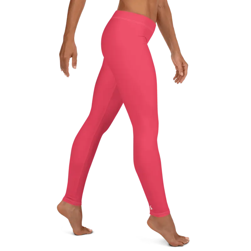 Legging de sport pour femme, effet seconde peau, de couleur rouge clair tirant vers le rose. Taille basse avec un élastique léger à la taille pour un maintien confortable sans compression. La photo montre le legging porté de profil.