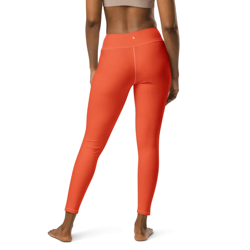 Legging de sport pour femme orange en nylon Éconyl, tissu léger sans couture, effet seconde peau pour un confort optimal. Photo porté du produit de derrière.