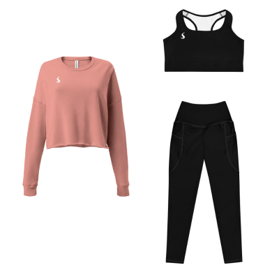 Tenue de sport pour femme composé d'un legging, d'une brassière noire et d'un pull rose.