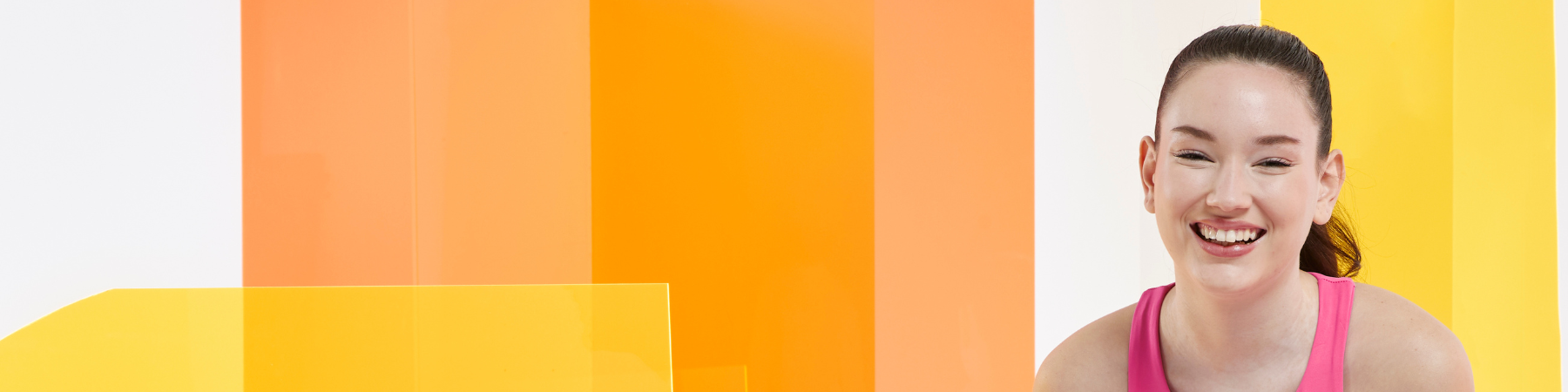 femme souriante sur un fond orange