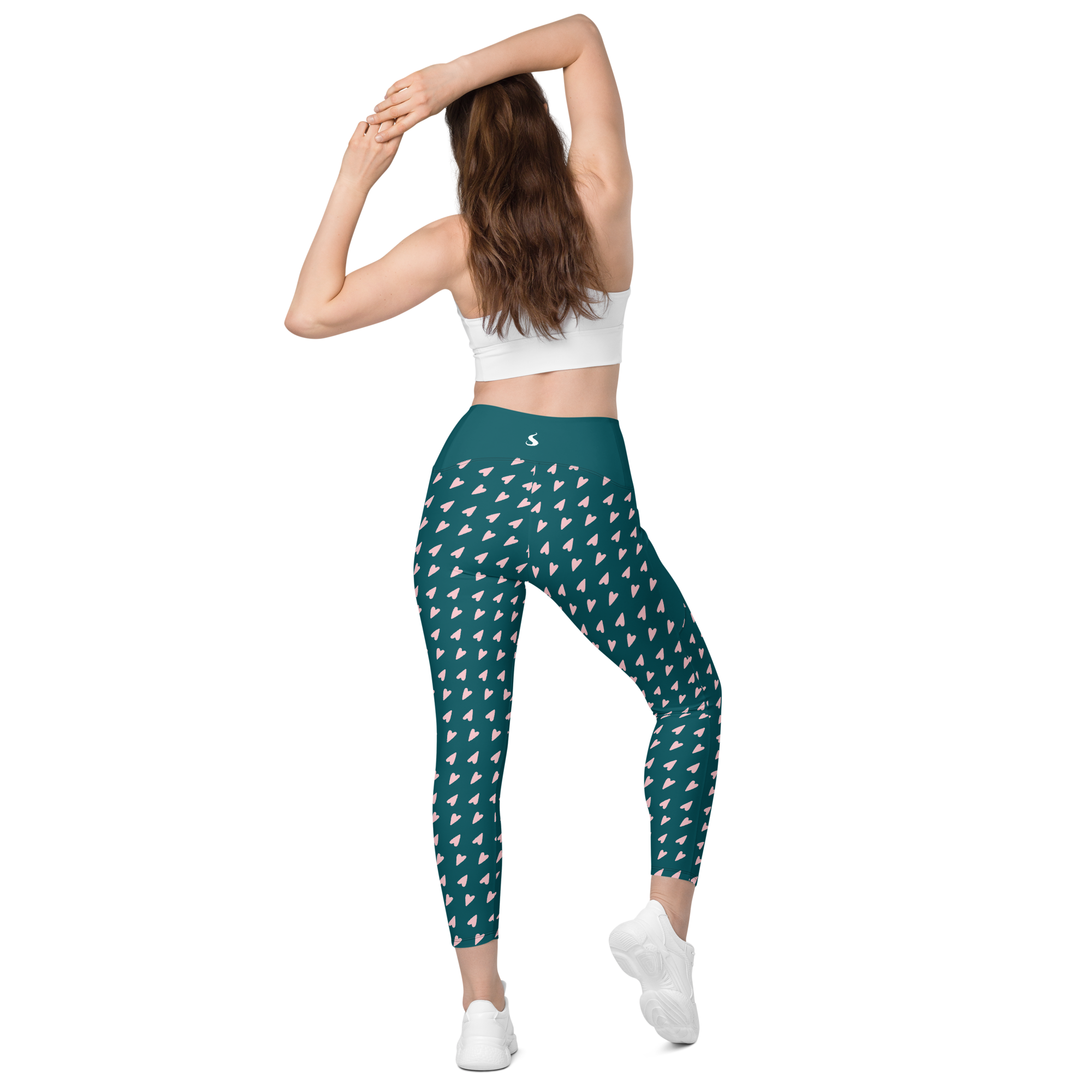 femme portant un legging vert à motifs roses de dos