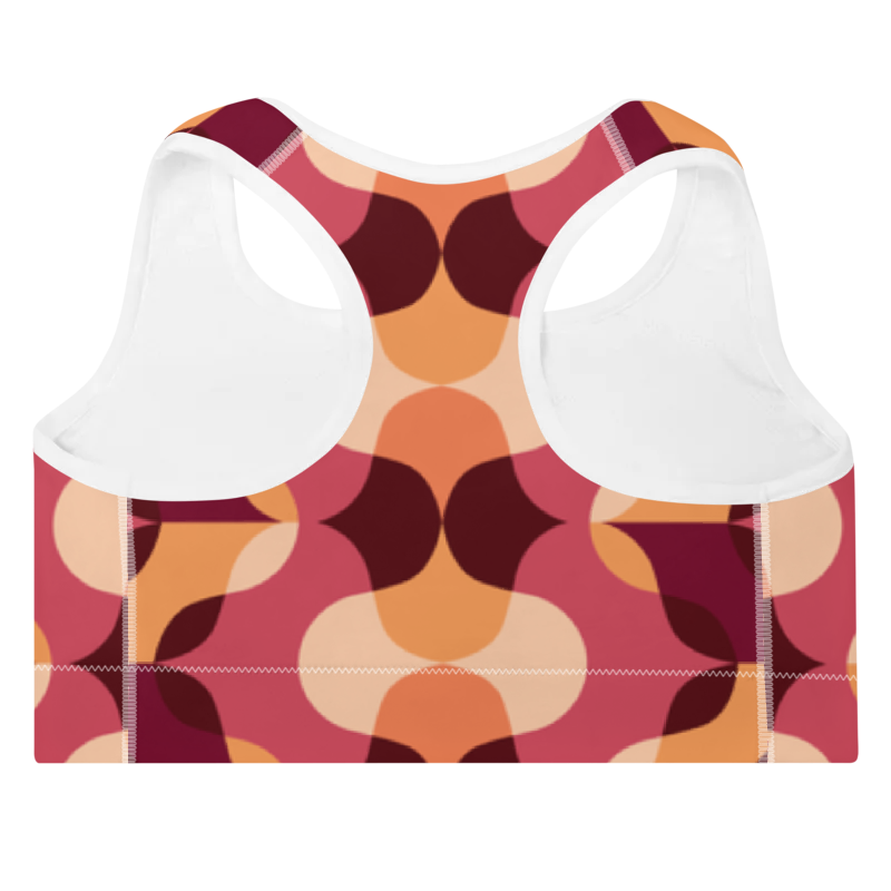 Brassière de sport Sweat Hold Up en nylon Econyl, douce et respirante, avec dos nageur pour un maintien léger. Disponible dans plusieurs motifs. Photo du produit de dos avec le motif Rétro avec les couleur orange, rose, bordeaux.