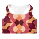 Brassière de sport Sweat Hold Up en nylon Econyl, douce et respirante, avec dos nageur pour un maintien léger. Disponible dans plusieurs motifs. Photo du produit de face avec le motif Rétro avec les couleur orange, rose, bordeaux.