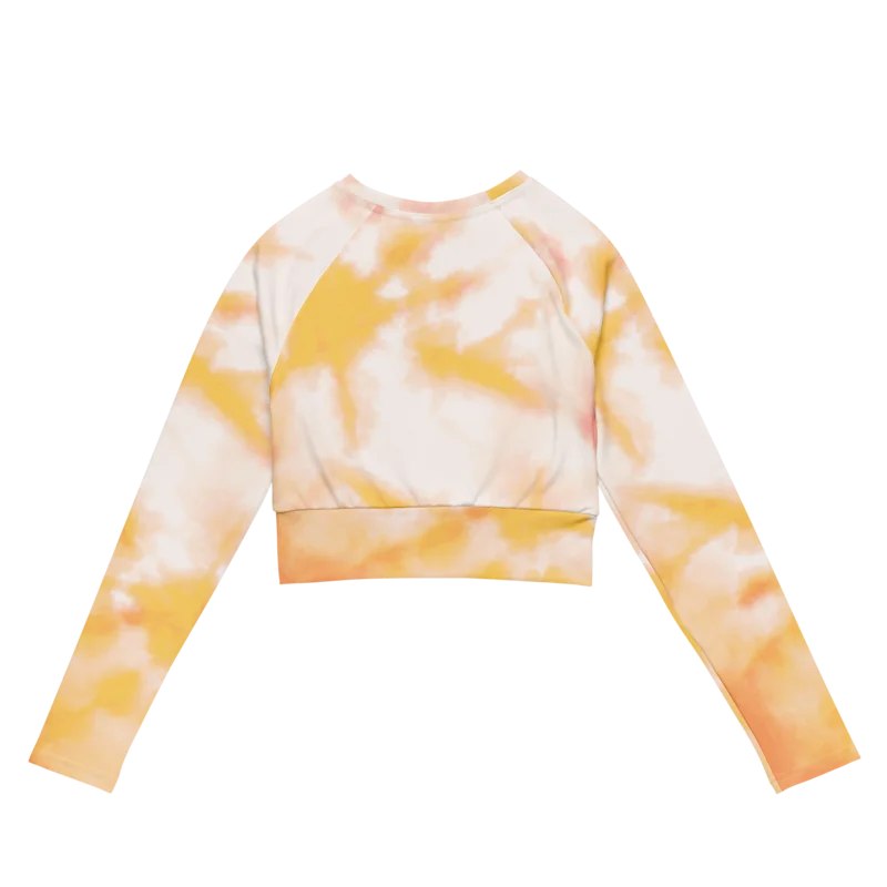 Crop top de sport Hot Focus à manches longues, motif tie and dye jaune et blanc, conçu pour allier confort et style lors des entraînements. Photo du produit de face.