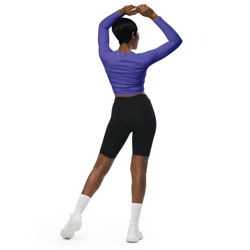 Crop top de sport Hot Focus à manches longues en coloris violet, conçu pour allier confort et style lors des entraînements. photo de dos porté par le mannequin.
