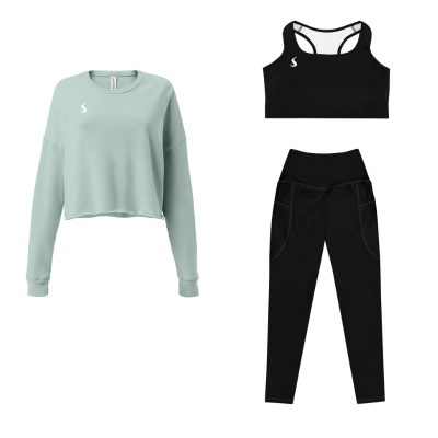 Ensemble de sport pour femme composé d'un legging et d'une brassière noire et d'un pull dans les tons vert d'eau.